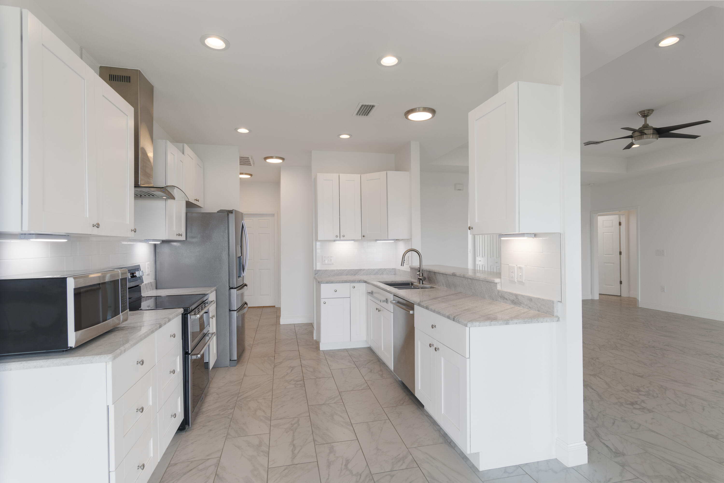 10 South Sunset Harbour Freeport, FL 32439 - Photo 22 of 57 a large kitchen with stainless steel appliances granite countertop a sink a stove a refrigerator and a oven