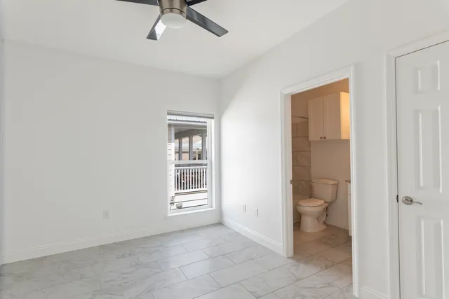 a view of a room with an empty space and a ceiling fan