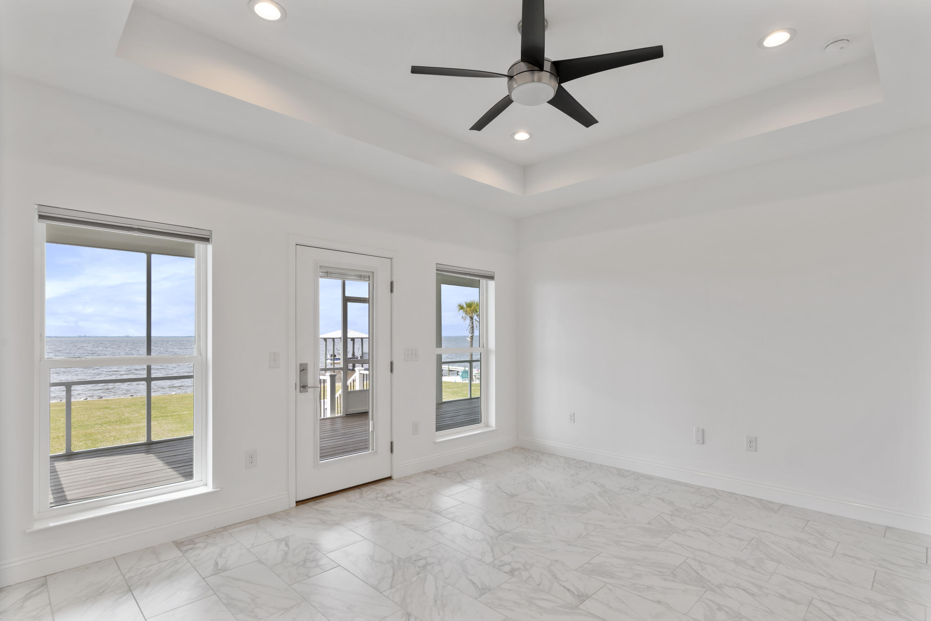 10 South Sunset Harbour Freeport, FL 32439 - Photo 35 of 57 en empty room with windows and chandelier fan