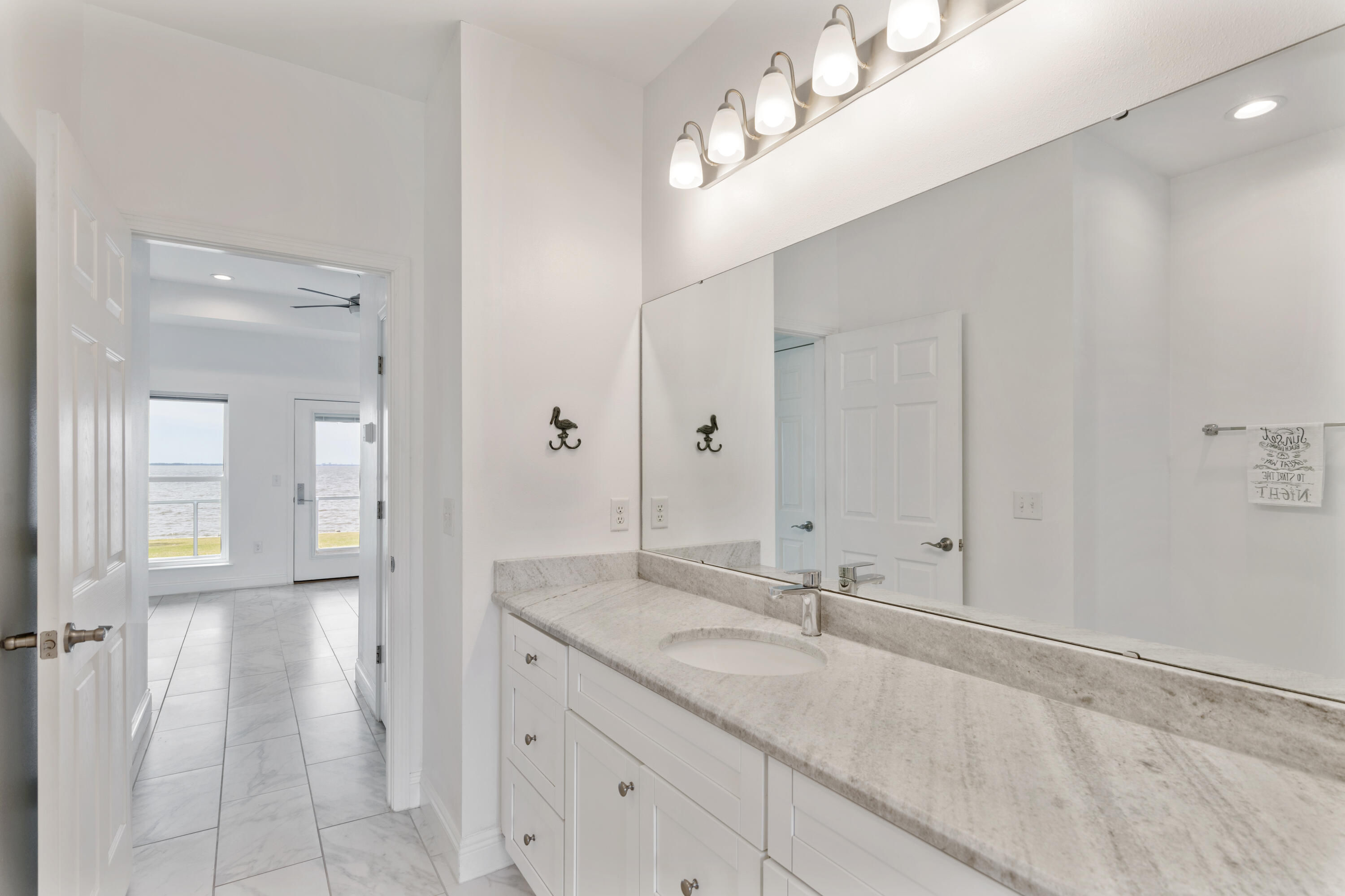 10 South Sunset Harbour Freeport, FL 32439 - Photo 37 of 57 a bathroom with a sink and a mirror