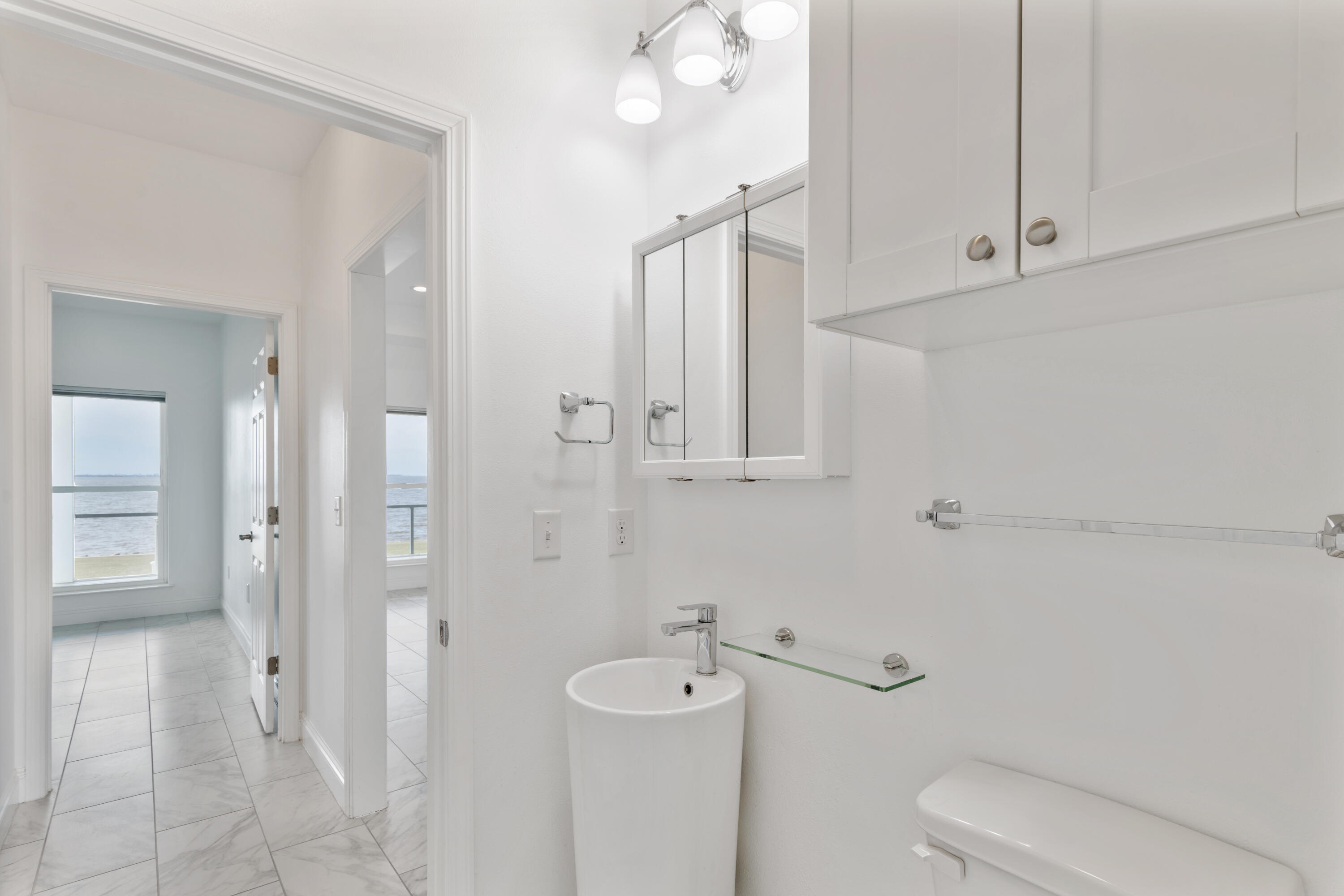 10 South Sunset Harbour Freeport, FL 32439 - Photo 40 of 57 a bathroom with a toilet a sink and mirror