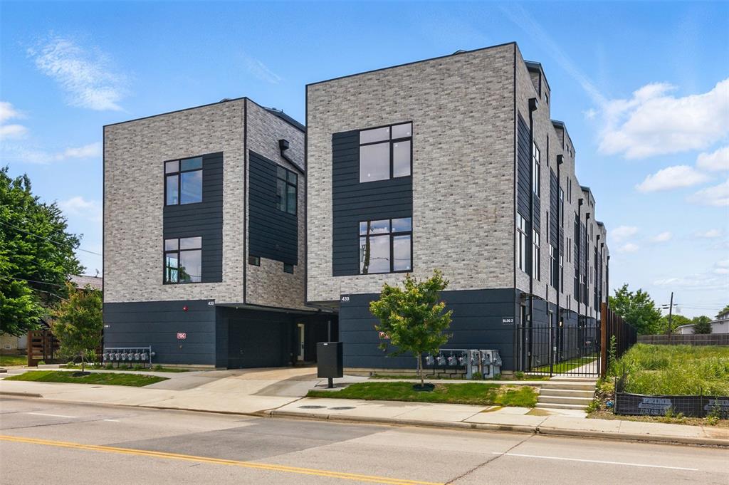 a view of a brick building next to a yard