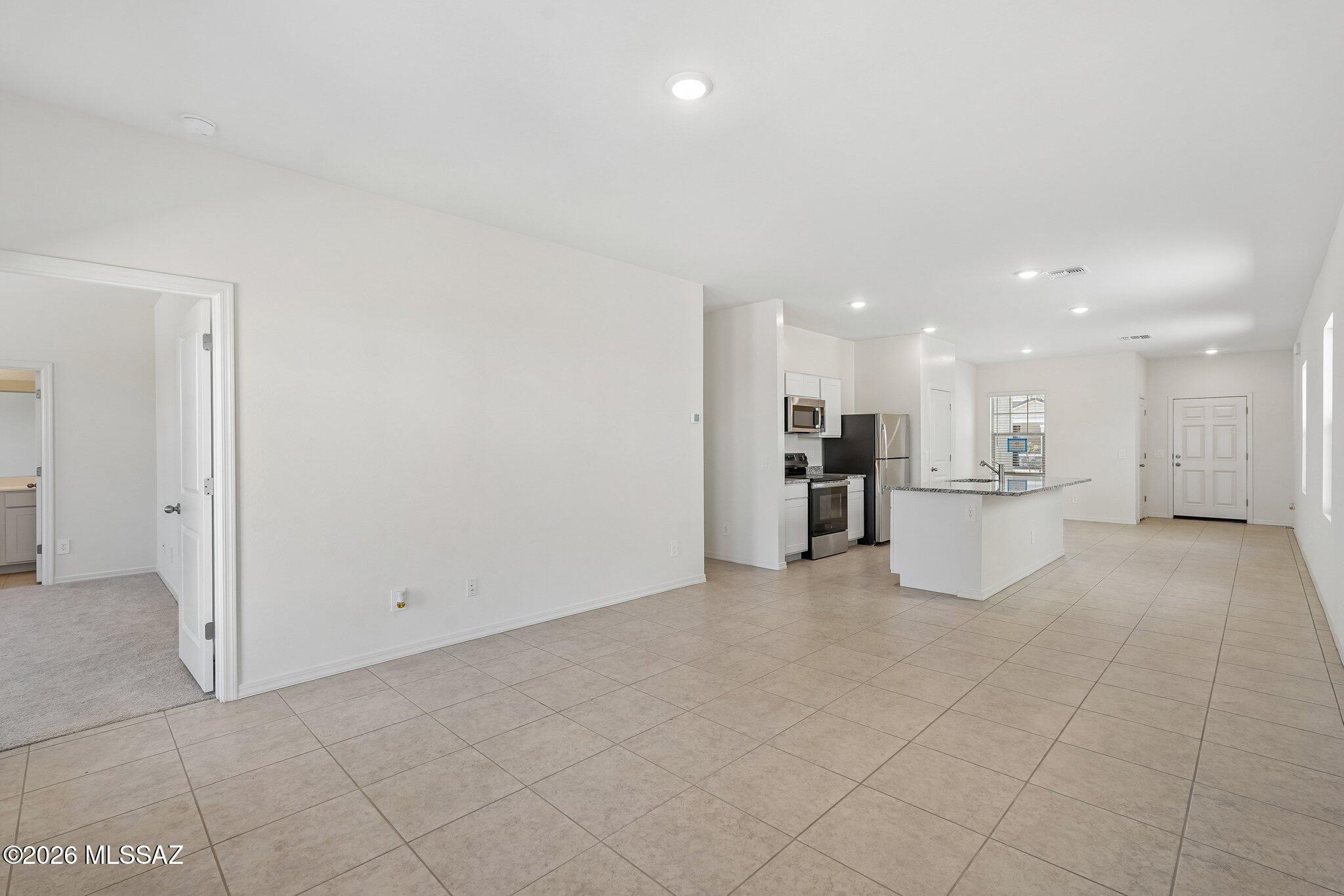 6735 West Star Wash Loop Tucson, AZ 85757 - Photo 12 of 16 SL_Sterling_Family_Room_Kitchen_B