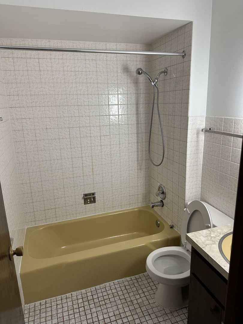 8020 West 84th Street Justice, IL 60458 - Photo 8 of 17 a bathroom with a sink a toilet and a bathtub