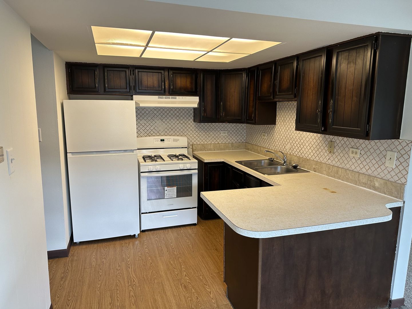 8020 West 84th Street Justice, IL 60458 - Photo 10 of 17 a kitchen with a sink and a refrigerator