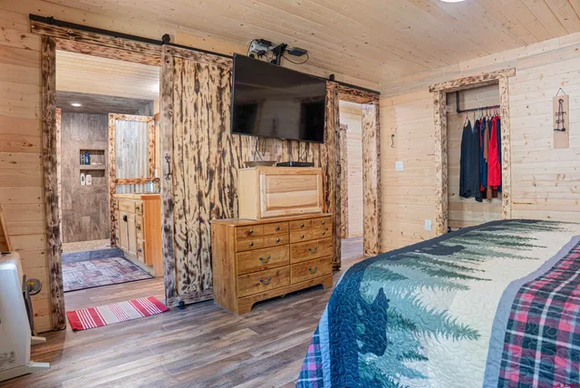 a bedroom with a bed and a television