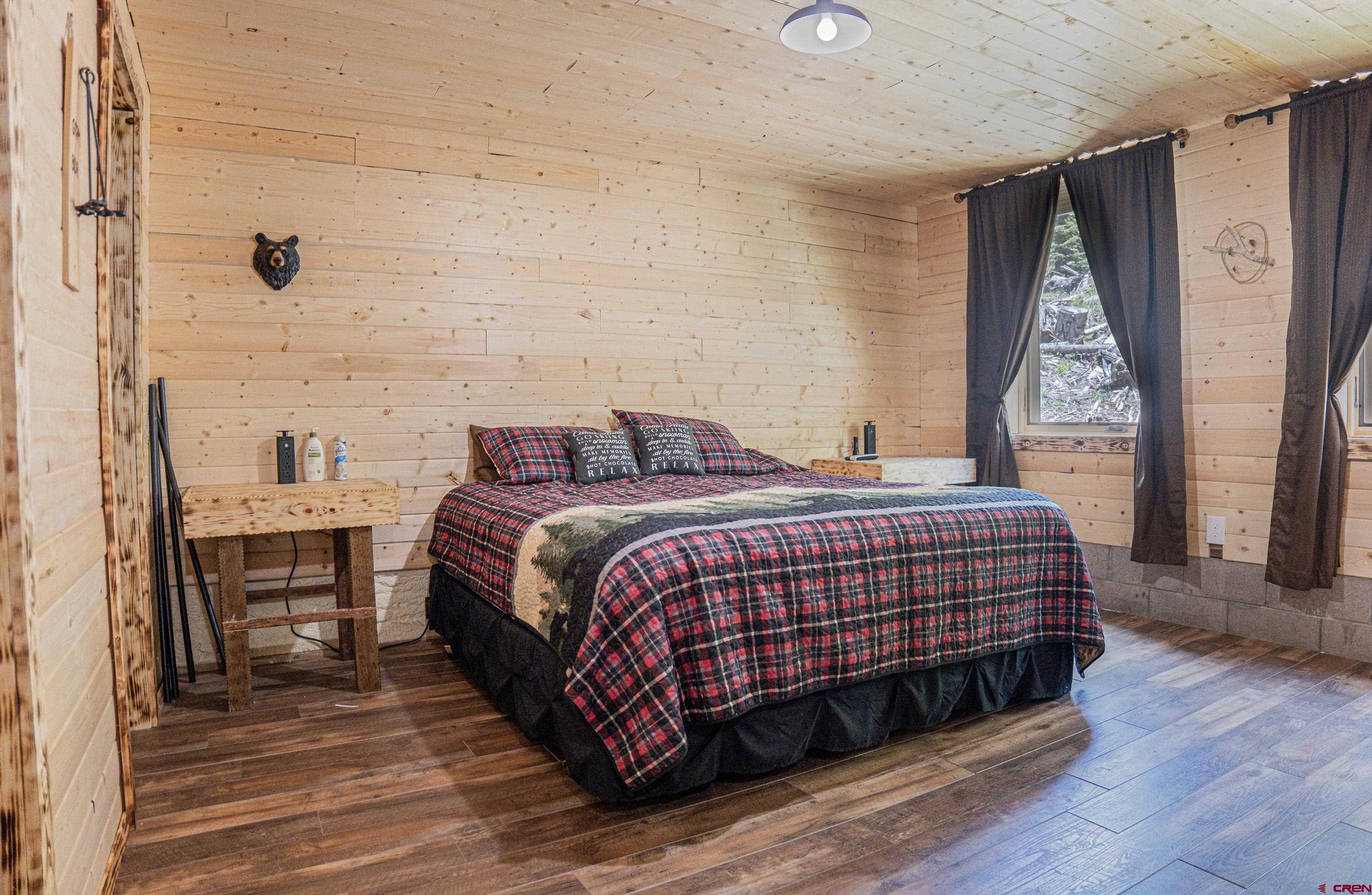 3300 County Road Silverton, CO 81433 - Photo 15 of 30 a bedroom with a bed and wooden floor