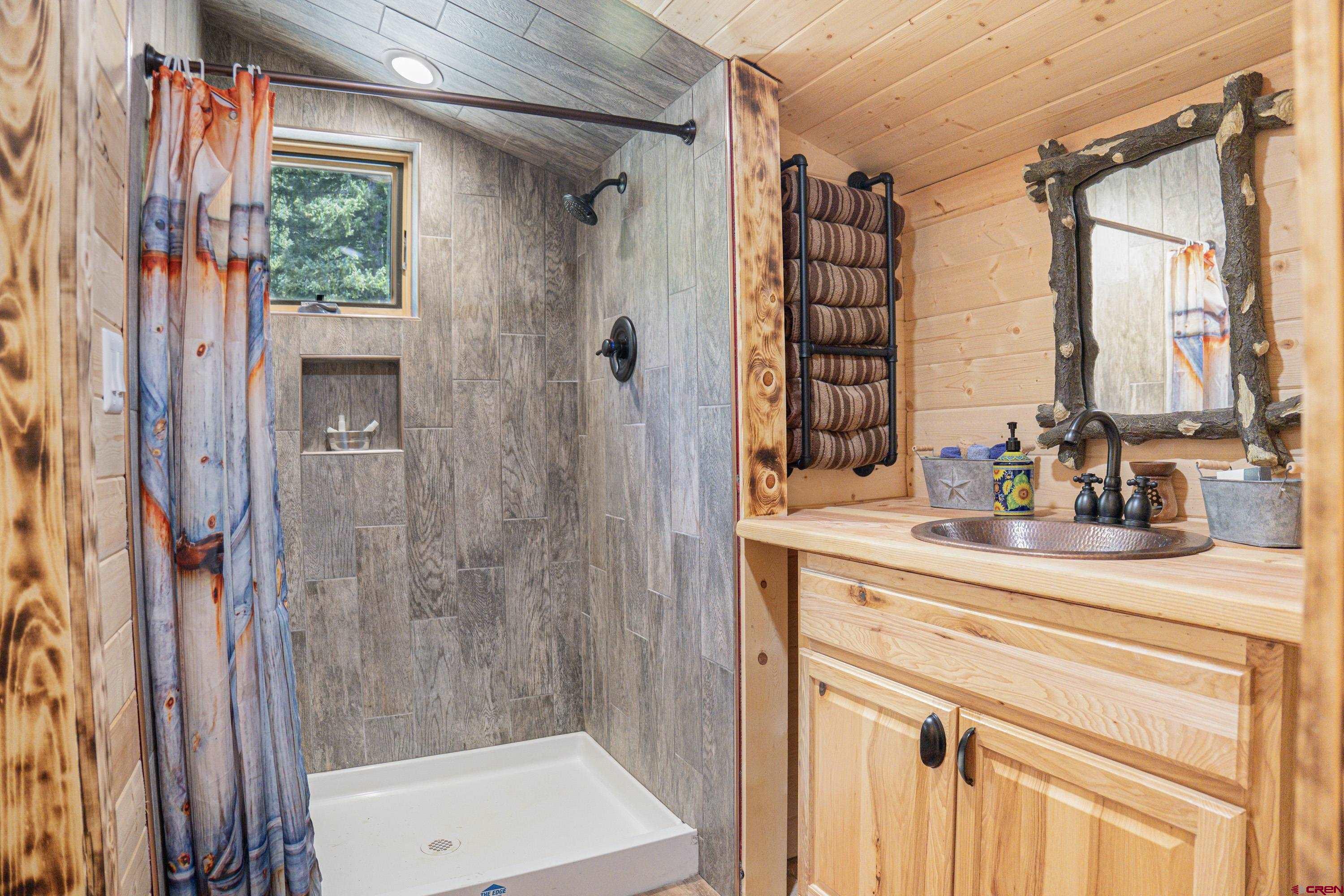 3300 County Road Silverton, CO 81433 - Photo 17 of 30 a bathroom with a shower curtain and a large window