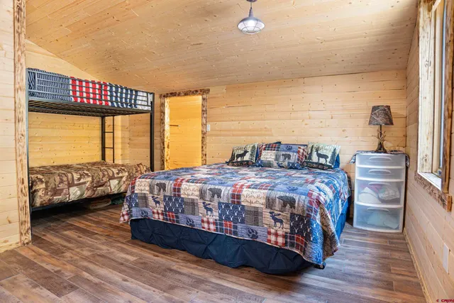 a bedroom with a bed a couch and a large window