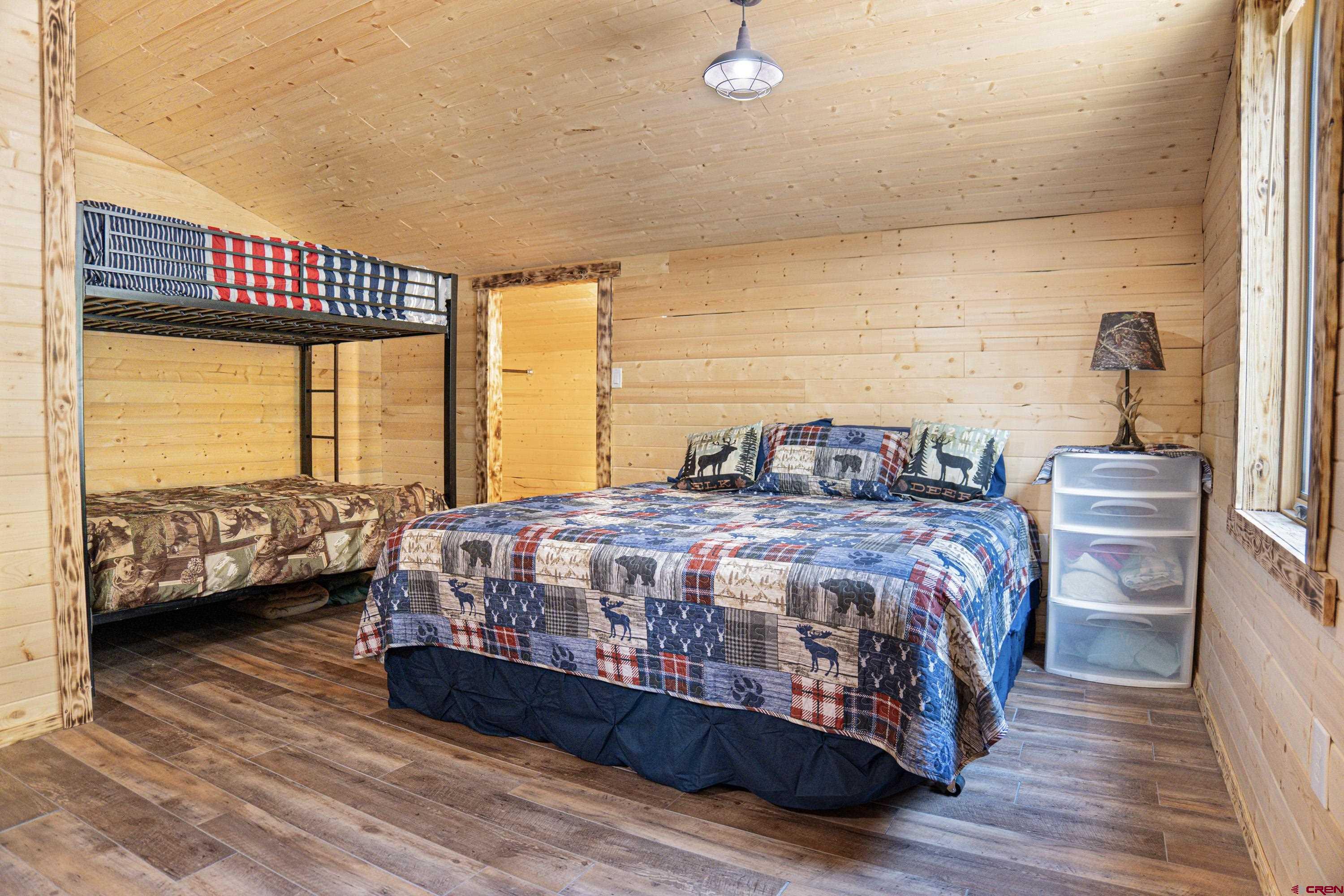 3300 County Road Silverton, CO 81433 - Photo 18 of 30 a bedroom with a bed a couch and a large window