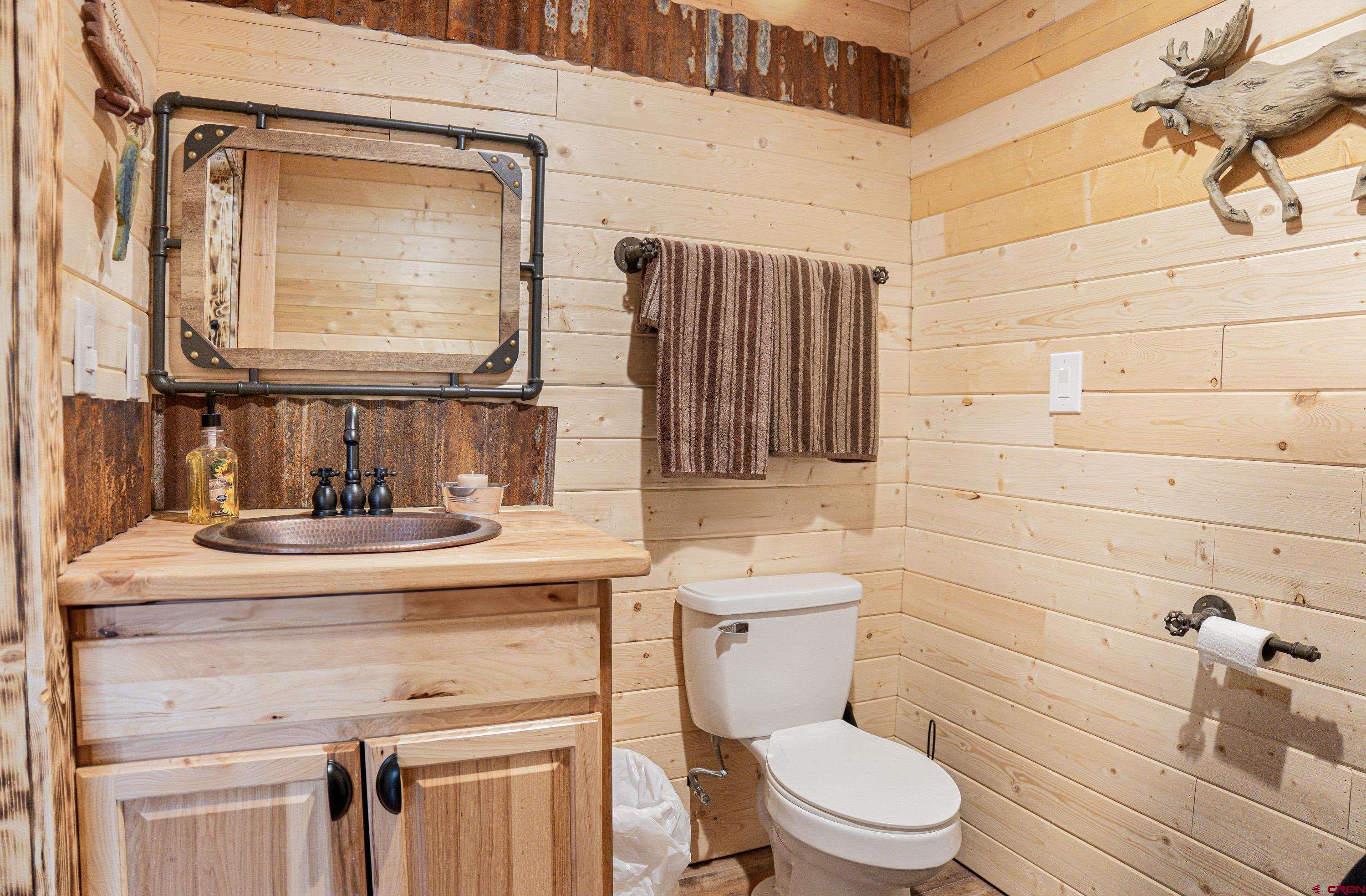 3300 County Road Silverton, CO 81433 - Photo 19 of 30 a bathroom with a toilet sink and mirror