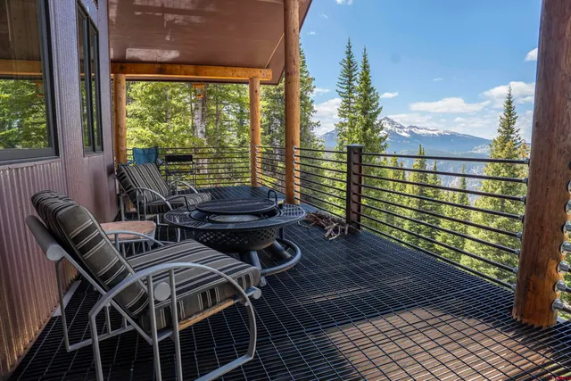 a view of a balcony with table and chairs and wooden floor