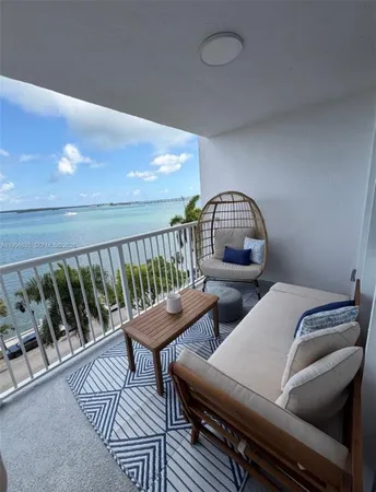 a view of a balcony with furniture