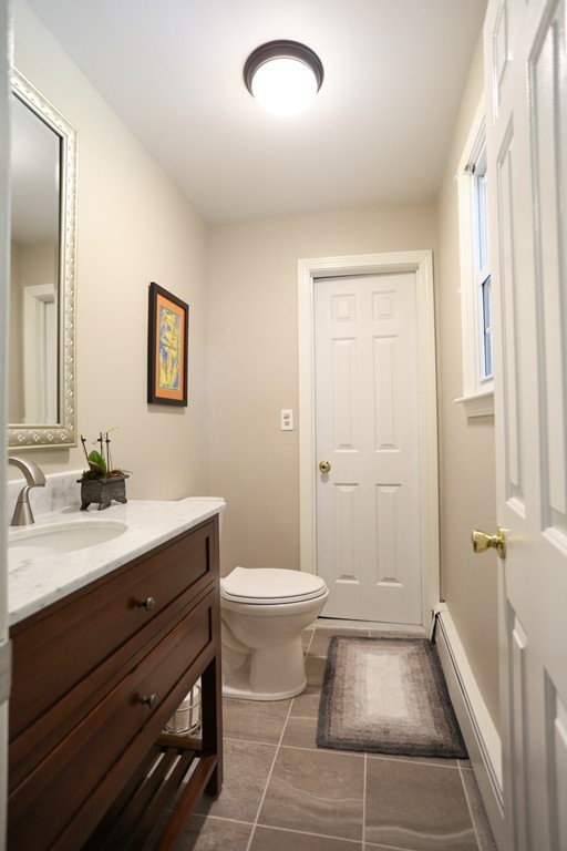 2 Woodside Road Framingham, MA 01701 - Photo 13 of 29 a bathroom with a sink a toilet a shower and a window