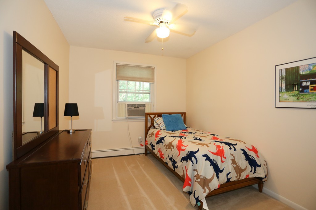 2 Woodside Road Framingham, MA 01701 - Photo 18 of 29 a bedroom with a bed and a chandelier