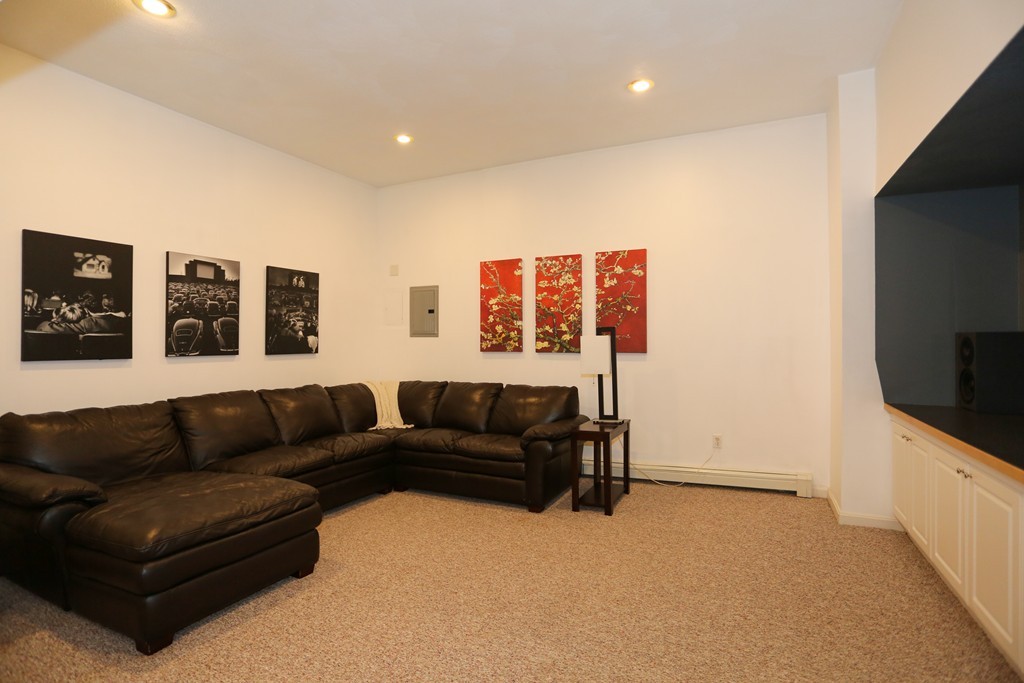 2 Woodside Road Framingham, MA 01701 - Photo 23 of 29 a living room with furniture and a flat screen tv