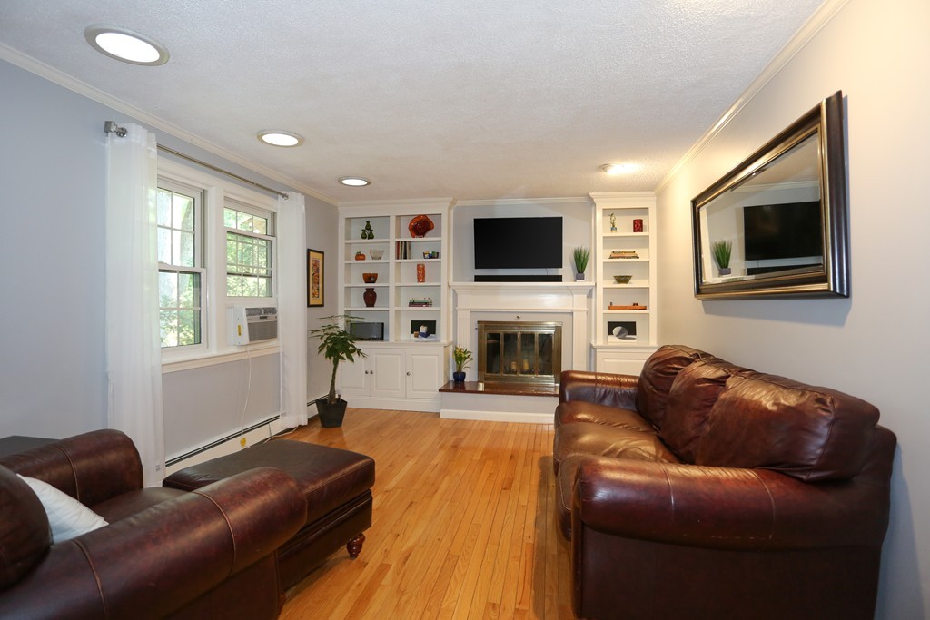 2 Woodside Road Framingham, MA 01701 - Photo 6 of 29 a living room with furniture a fireplace and a flat screen tv