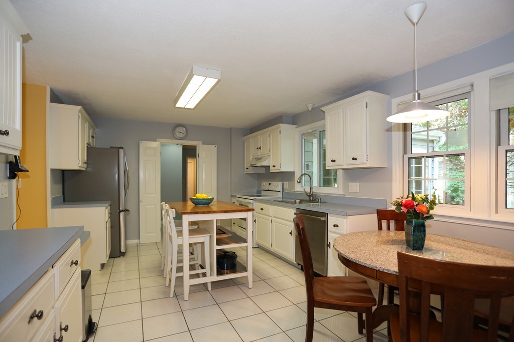 2 Woodside Road Framingham, MA 01701 - Photo 8 of 29 a kitchen with cabinets and chairs