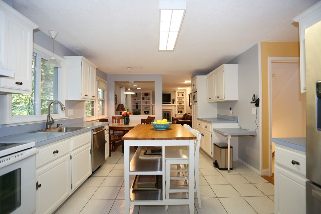 2 Woodside Road Framingham, MA 01701 - Photo 9 of 29 a kitchen with a sink stove and cabinets