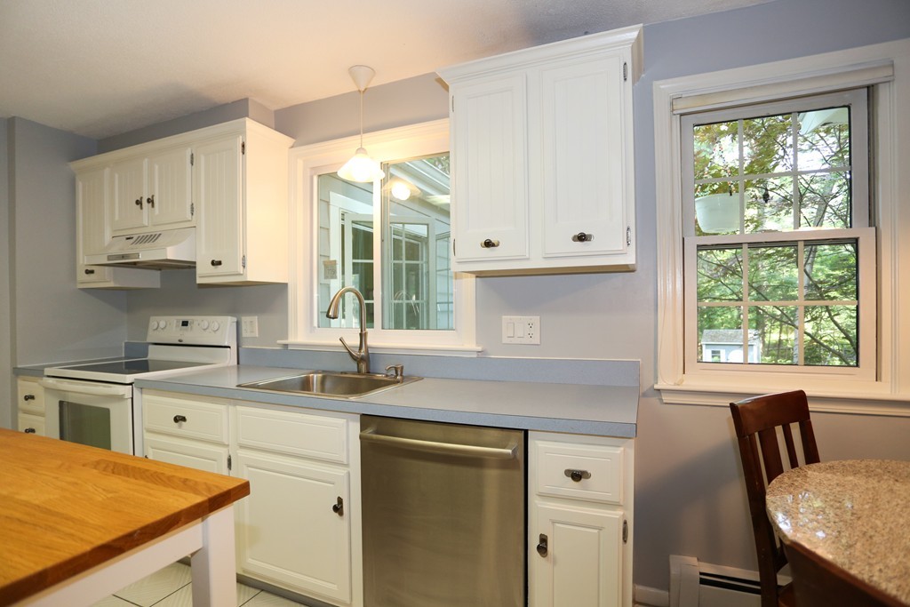 2 Woodside Road Framingham, MA 01701 - Photo 10 of 29 a kitchen with stainless steel appliances granite countertop a stove a sink and white cabinets