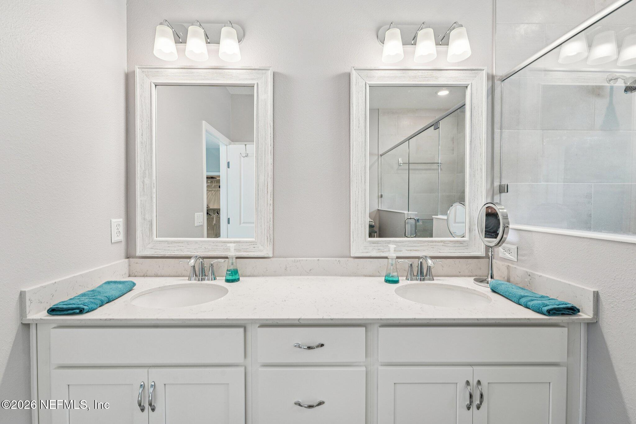 75682 Pondside Lane Yulee, FL 32097 - Photo 19 of 35 a bathroom with a sink and a mirror