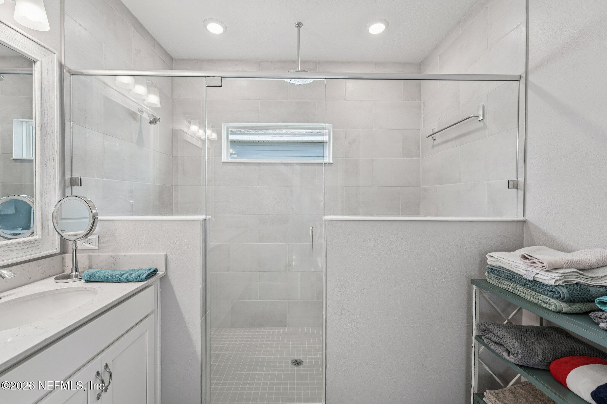 75682 Pondside Lane Yulee, FL 32097 - Photo 20 of 35 a bathroom with a granite countertop shower sink vanity and mirror