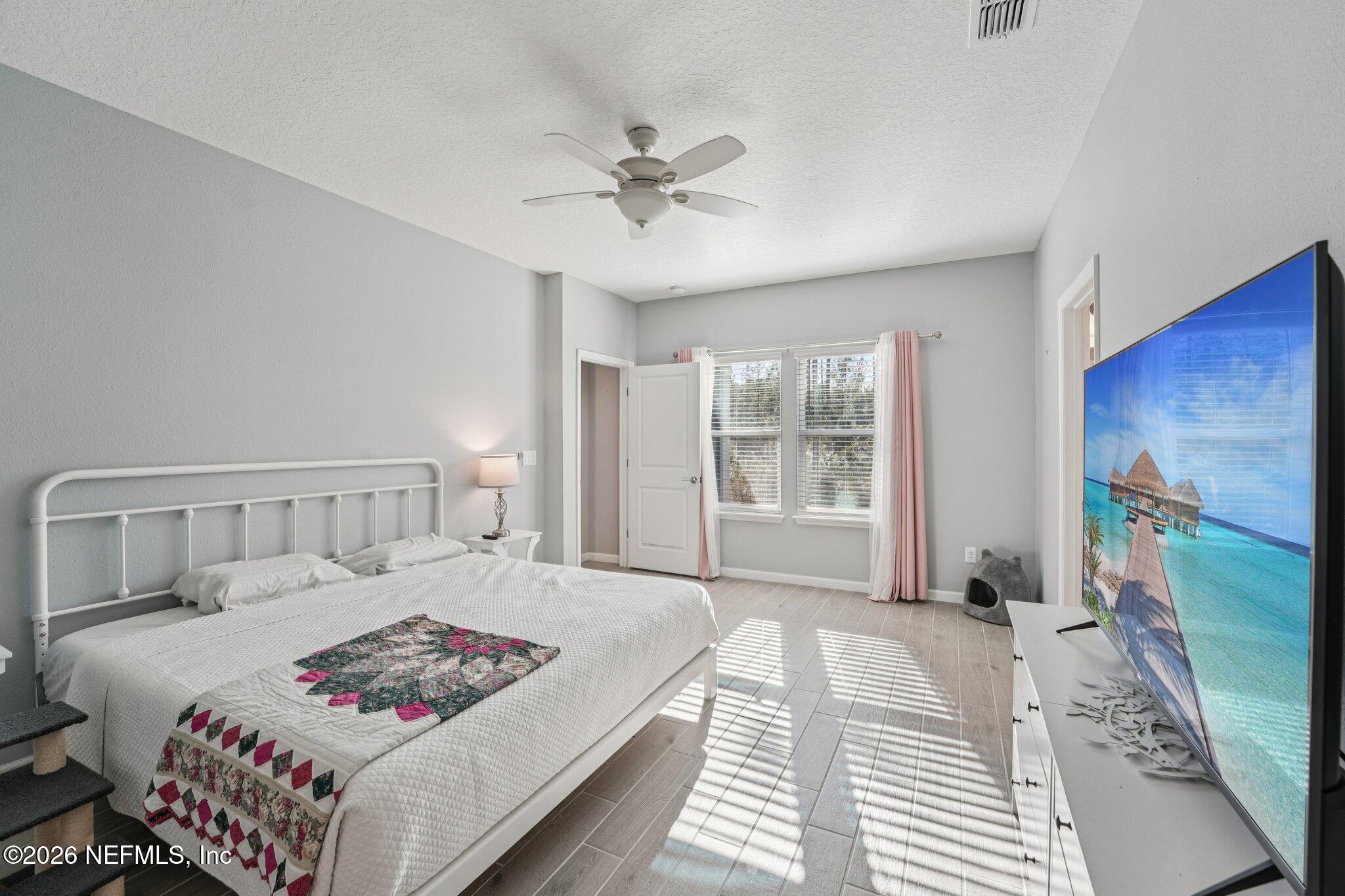 75682 Pondside Lane Yulee, FL 32097 - Photo 22 of 35 a bedroom with a bed and a window