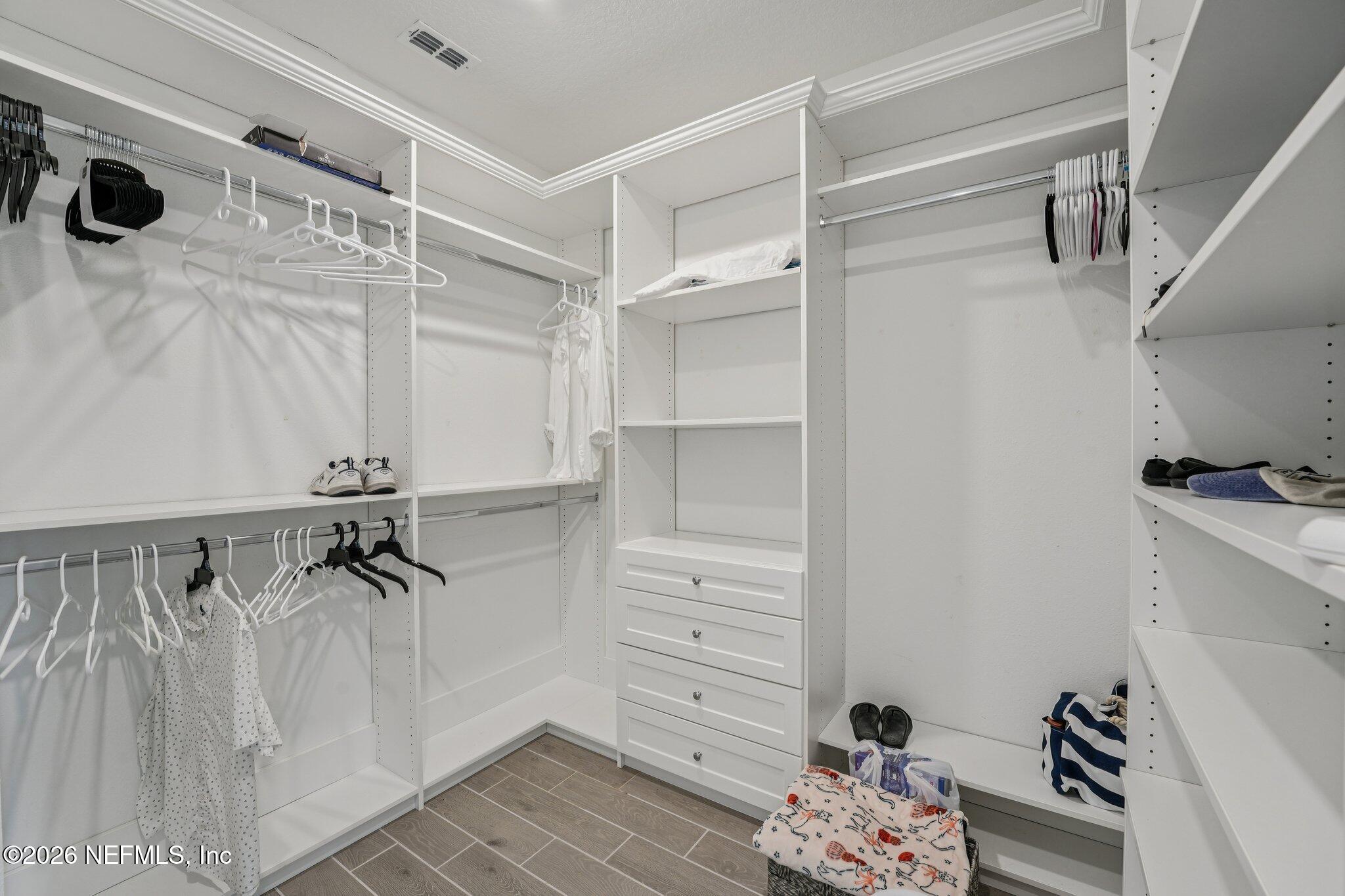 75682 Pondside Lane Yulee, FL 32097 - Photo 23 of 35 a view of walk in closet with clothes and shoes