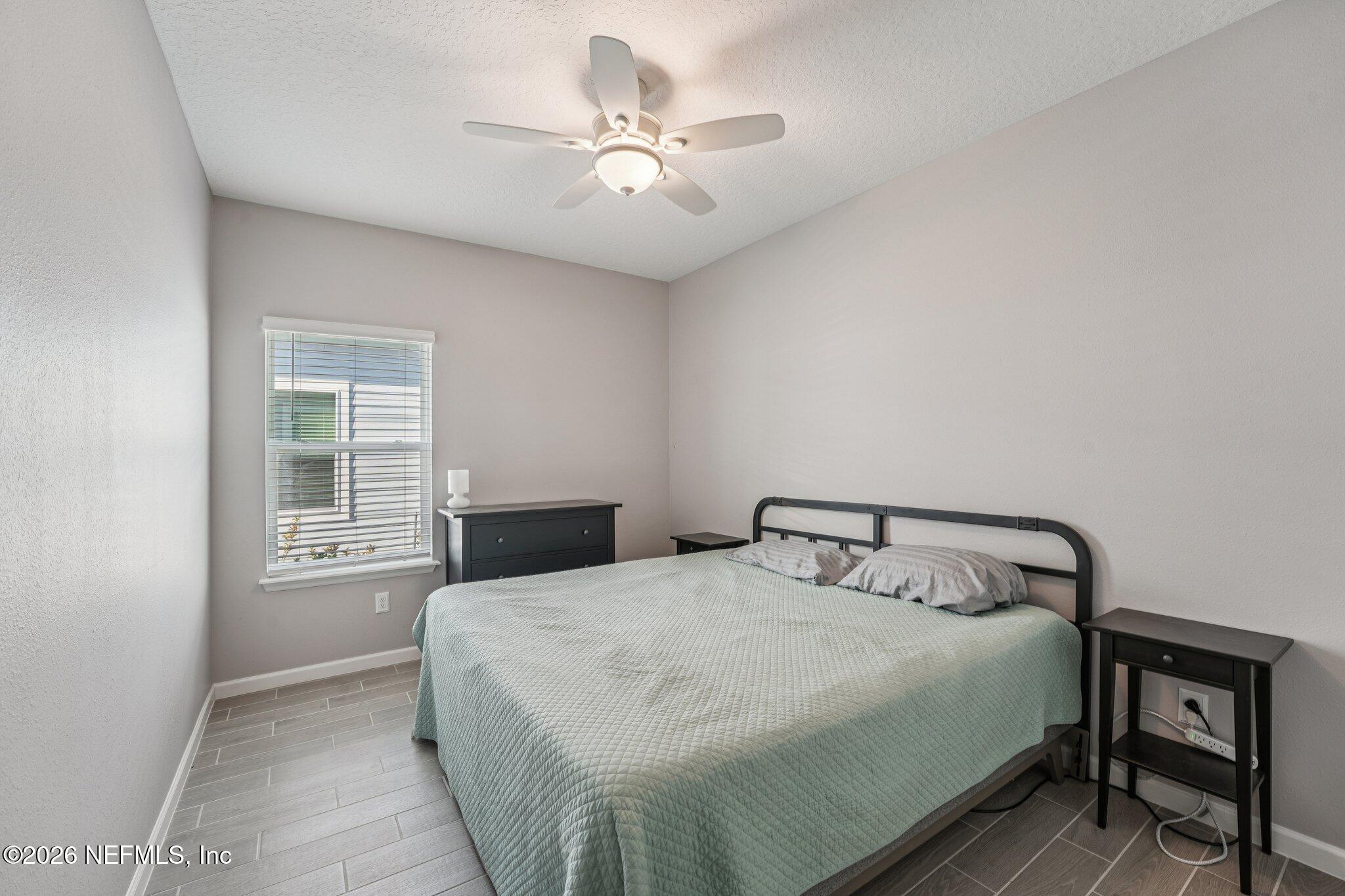 75682 Pondside Lane Yulee, FL 32097 - Photo 25 of 35 a bedroom with a bed and window