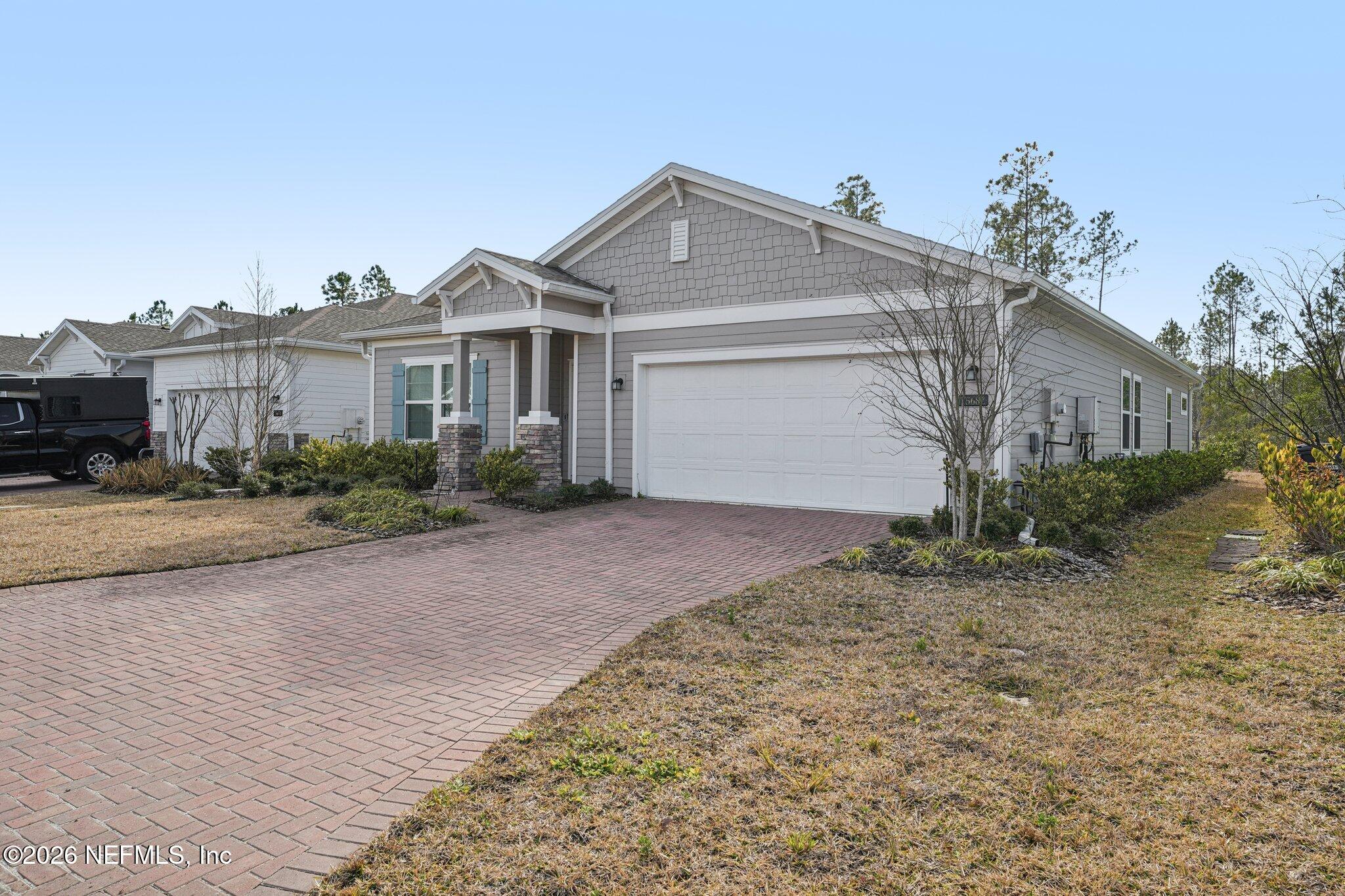 75682 Pondside Lane Yulee, FL 32097 - Photo 3 of 35 a front view of a house with garden