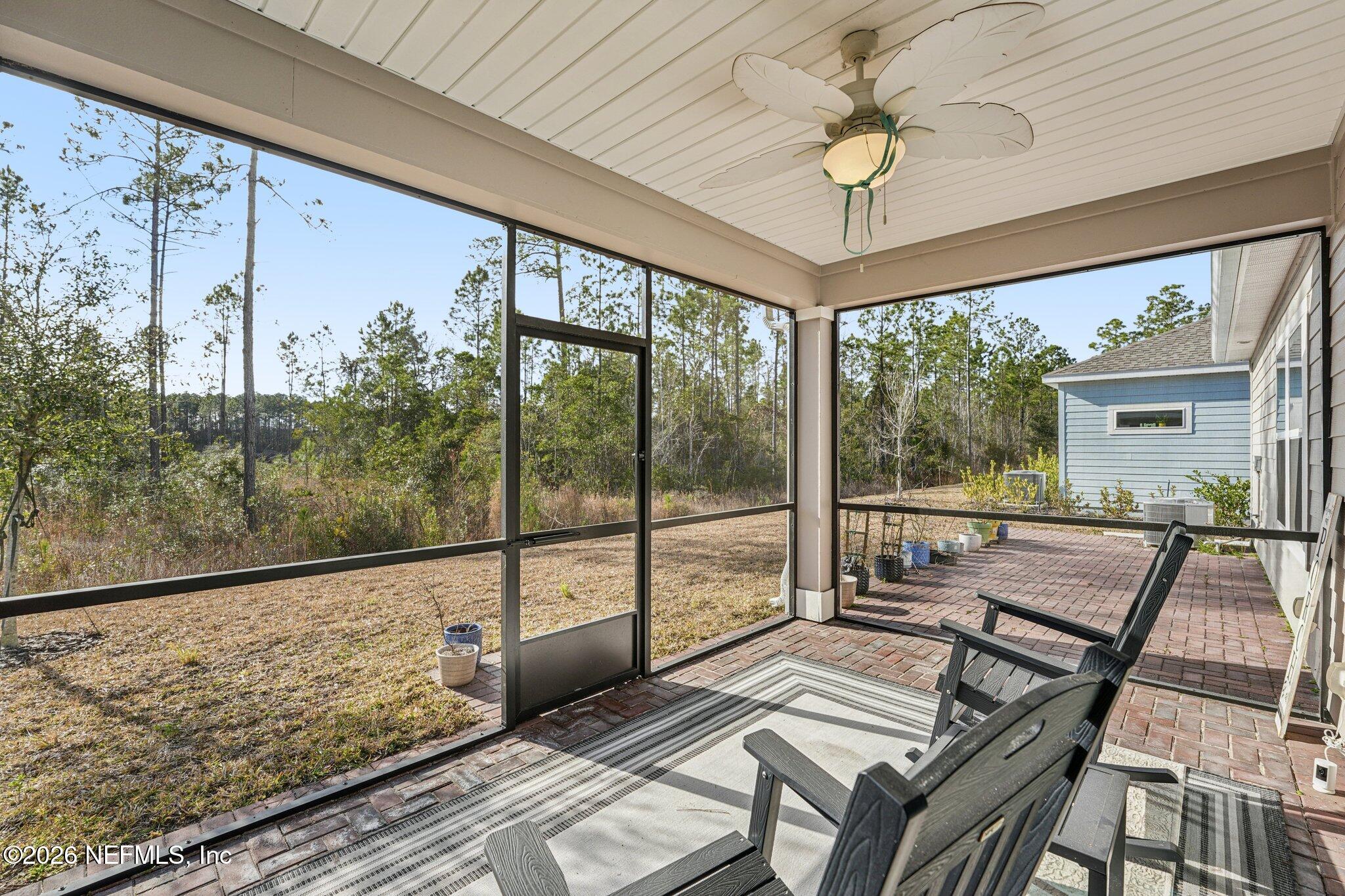 75682 Pondside Lane Yulee, FL 32097 - Photo 31 of 35 a view of a living room and a balcony