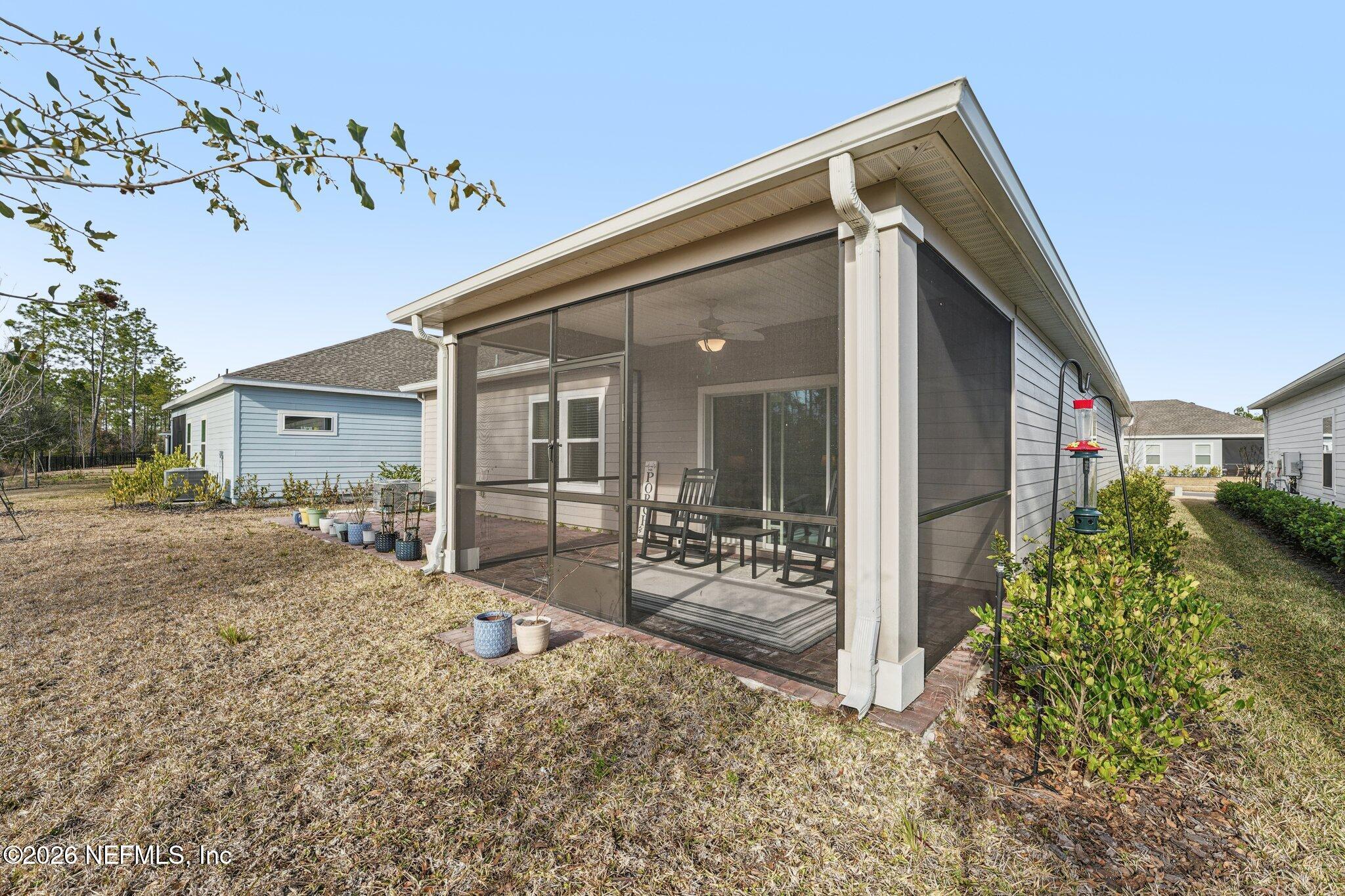 75682 Pondside Lane Yulee, FL 32097 - Photo 32 of 35 a front view of a house with garden