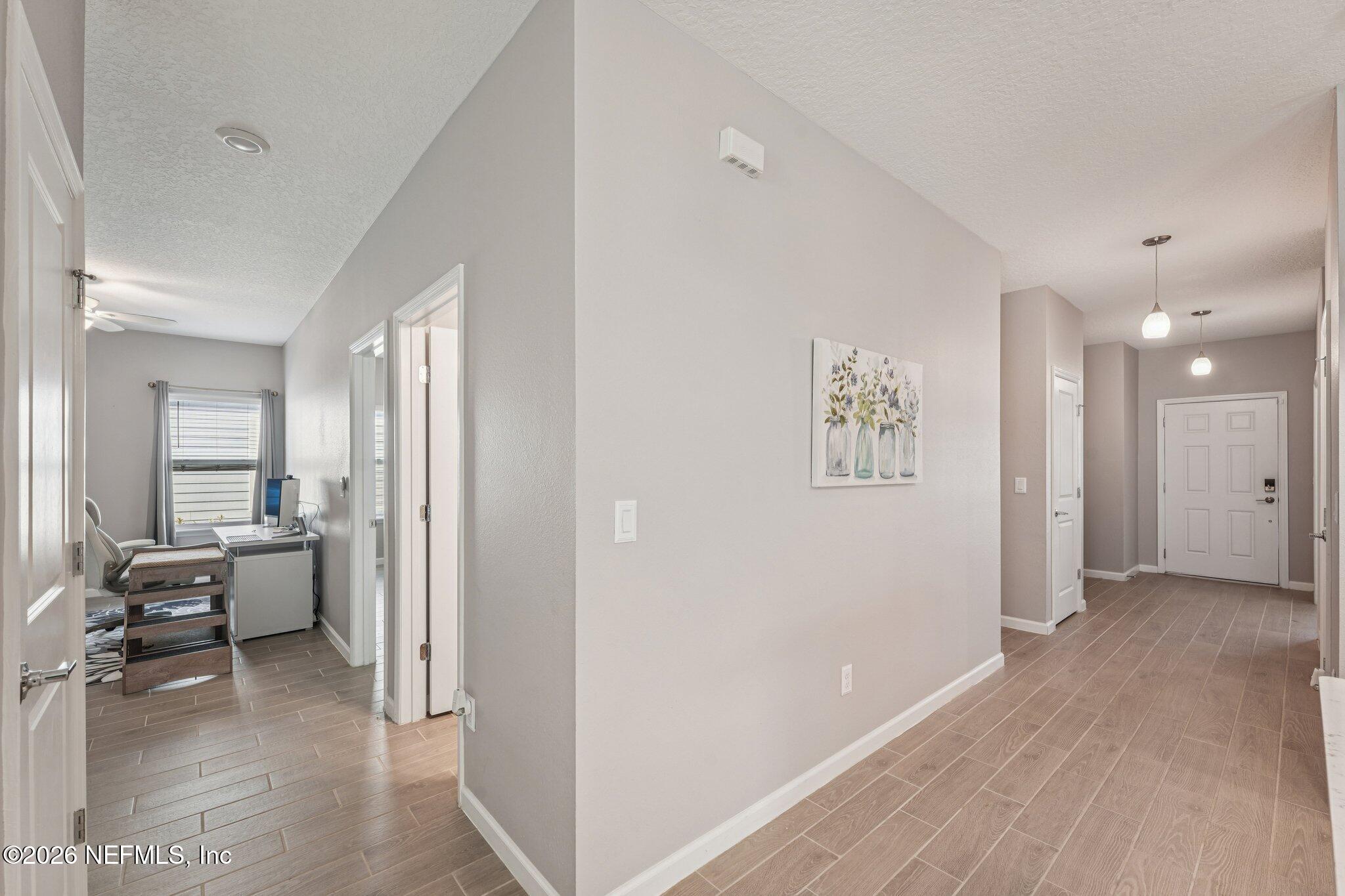 75682 Pondside Lane Yulee, FL 32097 - Photo 5 of 35 a view of a hallway with furniture and windows