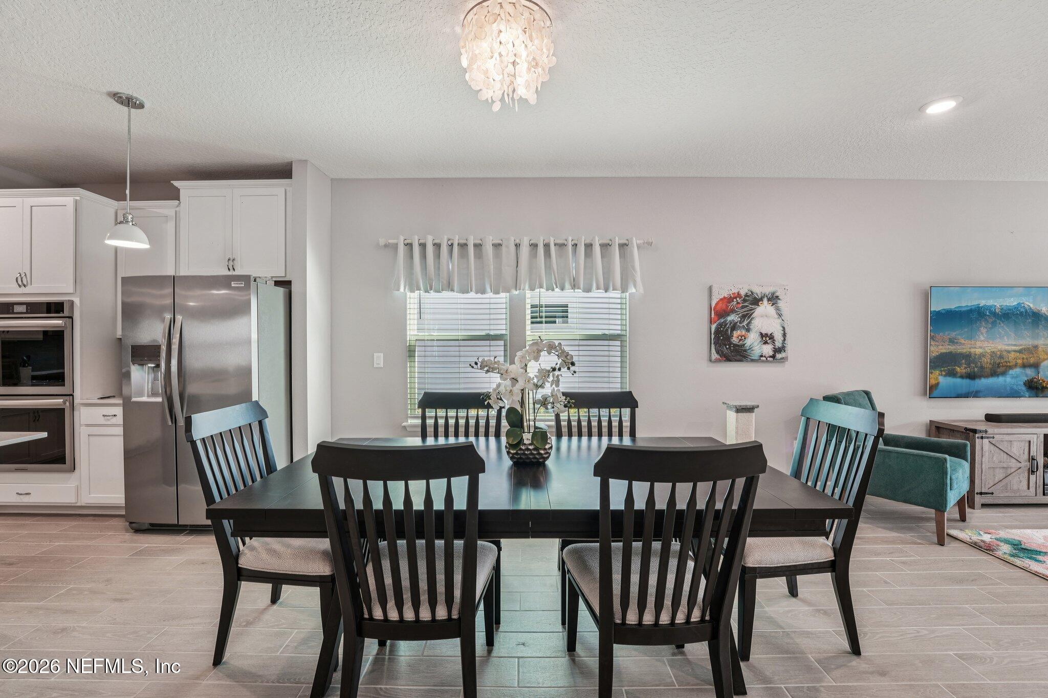 75682 Pondside Lane Yulee, FL 32097 - Photo 9 of 35 a view of a dining room with furniture