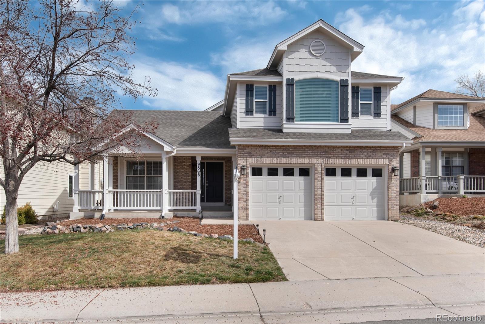 9866 Spring Hill Lane Highlands Ranch, CO 80129 - Photo 1 of 49 a front view of a house with garage