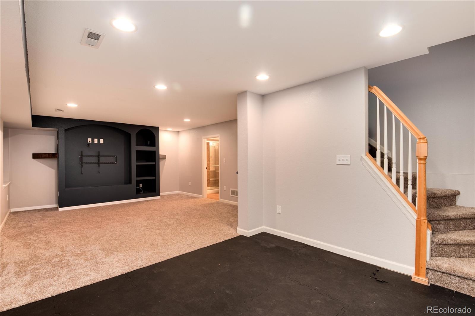 9866 Spring Hill Lane Highlands Ranch, CO 80129 - Photo 33 of 49 a view of an empty room with wooden floor