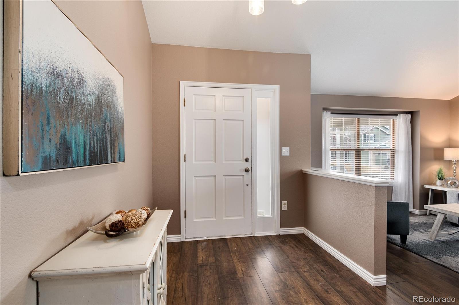 9866 Spring Hill Lane Highlands Ranch, CO 80129 - Photo 4 of 49 a room that has a window and wooden floor