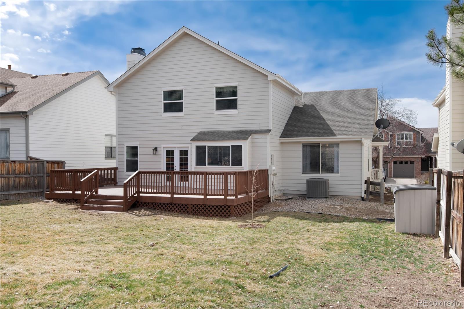 9866 Spring Hill Lane Highlands Ranch, CO 80129 - Photo 45 of 49 a view of a house with a yard and sitting area