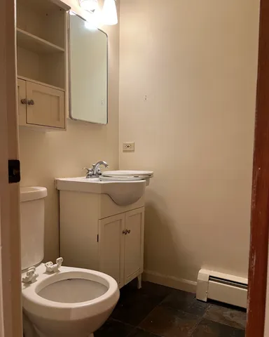 a bathroom with a sink a toilet and mirror