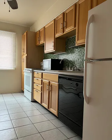 a kitchen with stainless steel appliances granite countertop a stove a refrigerator and a microwave