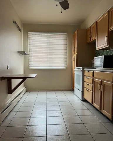 a kitchen with stainless steel appliances a sink a stove and cabinets