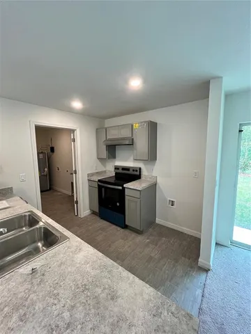 a kitchen with stainless steel appliances kitchen island granite countertop a sink and cabinets