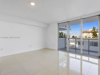a hallway with sliding door and front door