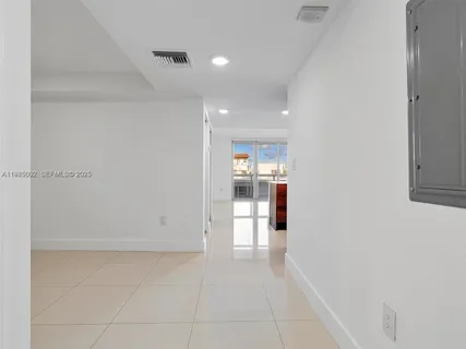 a view of kitchen and refrigerator