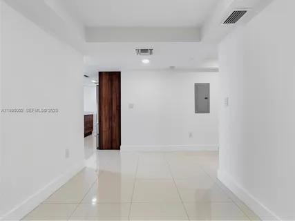 a view of a kitchen with refrigerator and cabinets
