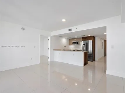 a kitchen with stainless steel appliances a refrigerator and a sink