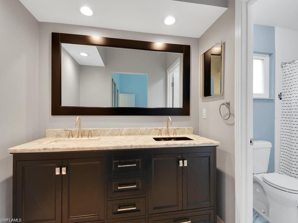 260 12th Street Southeast Naples, FL 34117 - Photo 12 of 29 a bathroom with a double vanity sink and a mirror