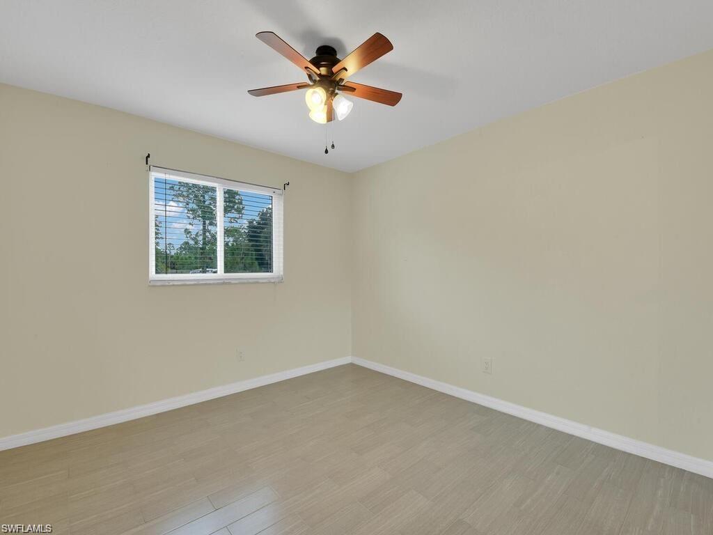 260 12th Street Southeast Naples, FL 34117 - Photo 13 of 29 an empty room with a window and a fan