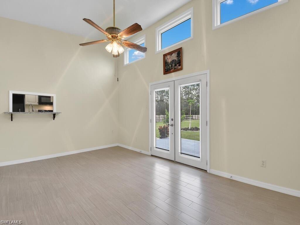 260 12th Street Southeast Naples, FL 34117 - Photo 16 of 29 a view of an empty room with a window and a ceiling fan