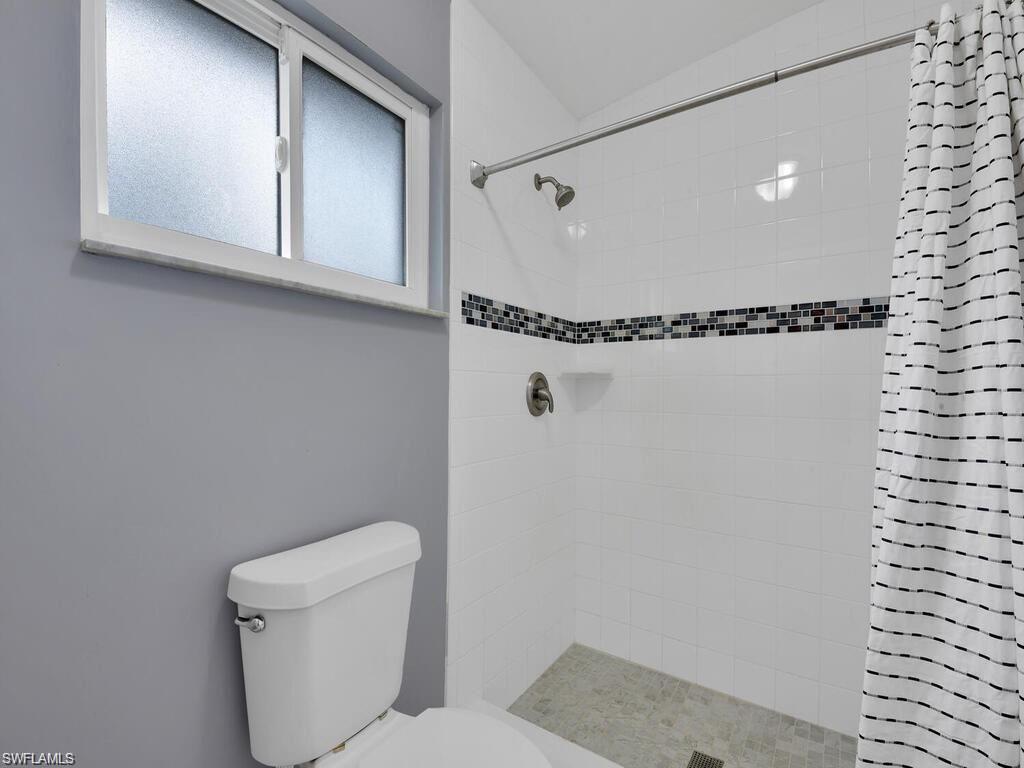 260 12th Street Southeast Naples, FL 34117 - Photo 20 of 29 a bathroom with a toilet and a shower